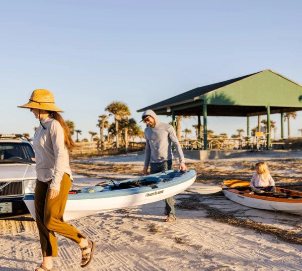 Couple carrying lightweight kayak