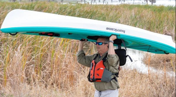 Man holding a Kayak