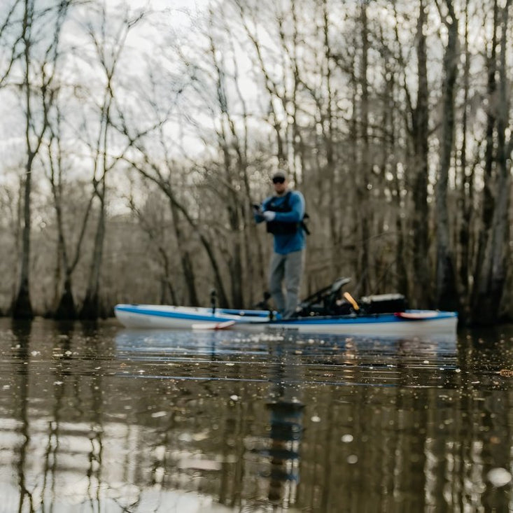 Man standing on fishing kayak