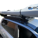 Car with a Carbonology Boost Ski on a y -Rack roof rack against a white background