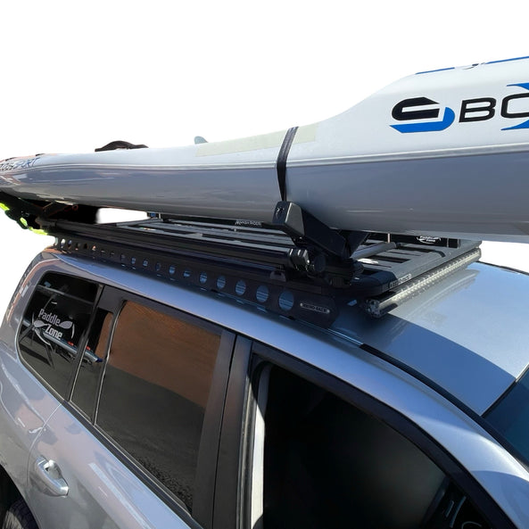 Car with a Carbonology Boost Ski on a y -Rack roof rack against a white background